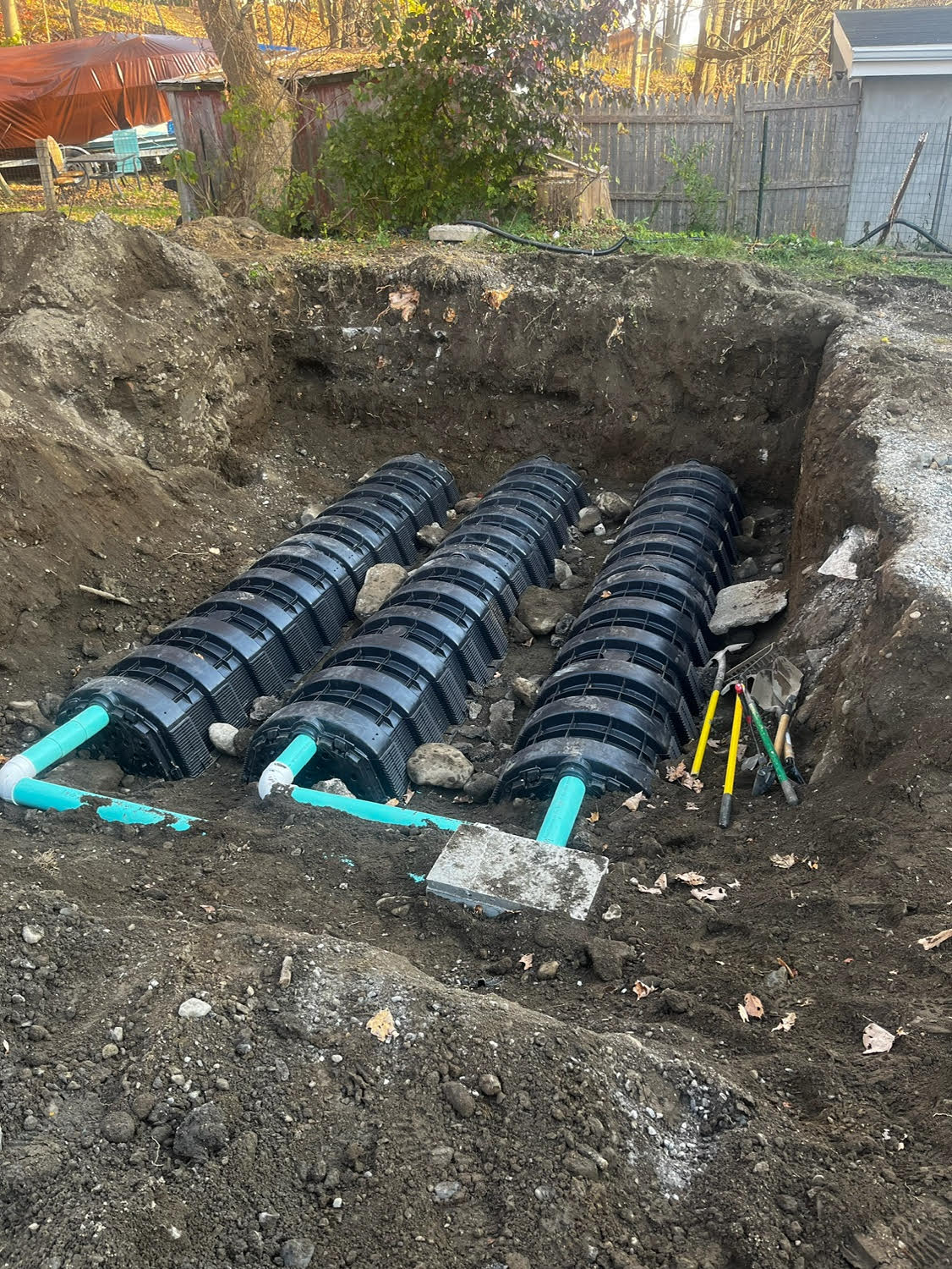 An image of an installation for septic tanks to dispose of waste from the house. Before excavation: Green, plastic septic ...